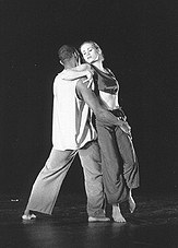 Boris Willis and Cynthia McLaughlin in a close embrace on a dark stage in Cocteau Variations