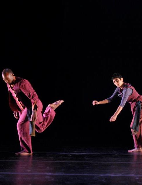 Boris Willis lifting Sharon Mansur in a burgundy-lit duet