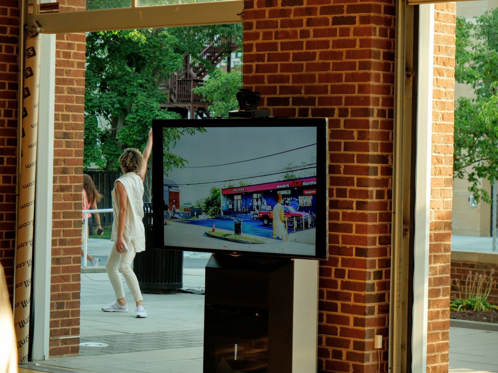 A dancer performing beside a screen showing a real-time rendered street in ReVision 10
